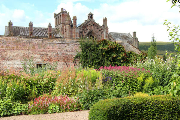 Melrose Abbey over walls of Priorwood Garden. Melrose, Scotland.