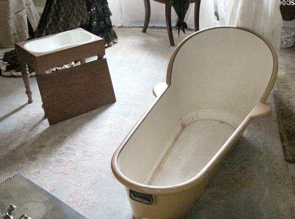 Portable tin bathtub beside portable bidet in dressing room at Traquair House. Scotland.