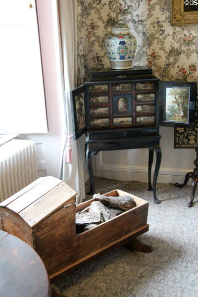 Cradle & Flemish cabinet (1600s) with small drawers in lower drawing room at Traquair House. Scotland.