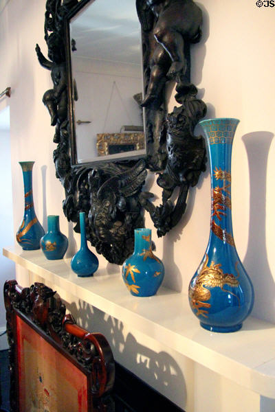 Carved mirror frame over blue glass vases with Chinese themes in gold in king's bedroom at Glamis Castle. Angus, Scotland.