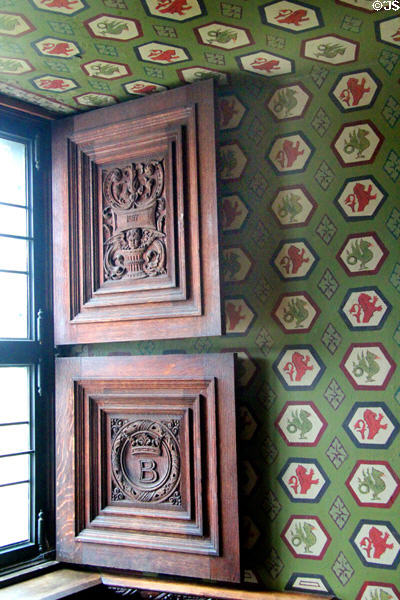 Carved window shutters against wallpaper at Falkland Palace. Falkland, Scotland.