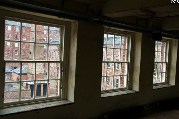 Workers toilet chute tower in corner of factory floor at Stanley Mills. Stanley, Scotland.