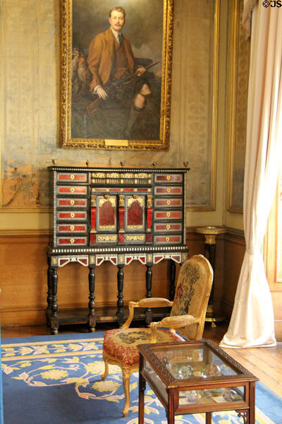 Portrait of 7th Earl of Mansfield by Philip de Laszlo over inlaid buhlwork cabinet in state drawing room at Scone Palace. Perth, Scotland.