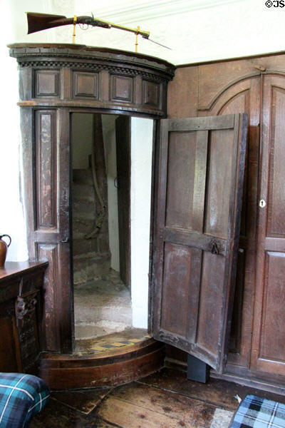Corner door to hidden spiral staircase in The Hall at Craigievar Castle. Alford, Scotland.