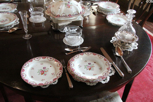Porcelain place setting & wine decanter in dining room at Drum Castle. Drumoak, Scotland.