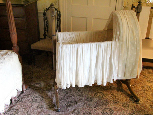 Swinging cradle on flat-woven Scotch carpet at Castle Fraser. Aberdeenshire, Scotland.