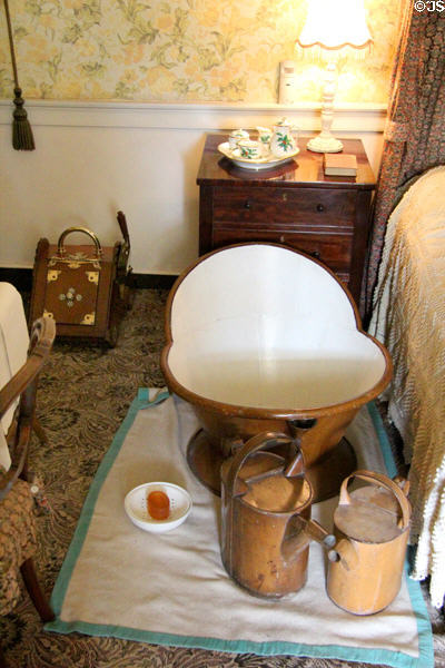 Hip bath with filling hot water cans carried by hand from three floors below in Green Room at Castle Fraser. Aberdeenshire, Scotland.