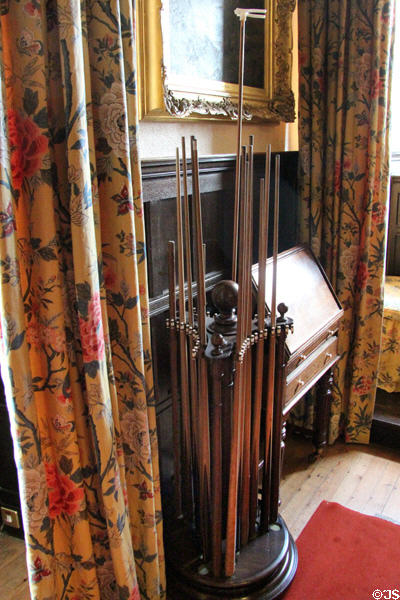 Rack of cue sticks in billiard room at Fyvie Castle. Turriff, Scotland.