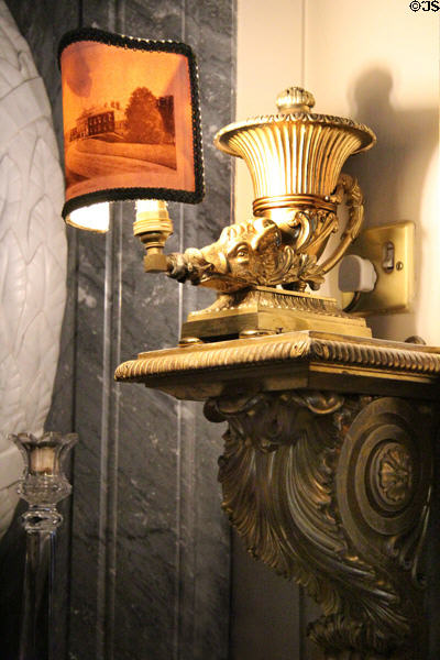 Lamp held by sculpted boar flanking fireplace in upstairs hall at Haddo House. Methlick, Scotland.