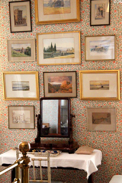 Collection of scenic watercolors over bedroom table mirror at Haddo House. Methlick, Scotland.