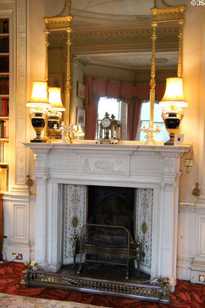 Morning room fireplace with mantle mirror & lamps at Haddo House. Methlick, Scotland.