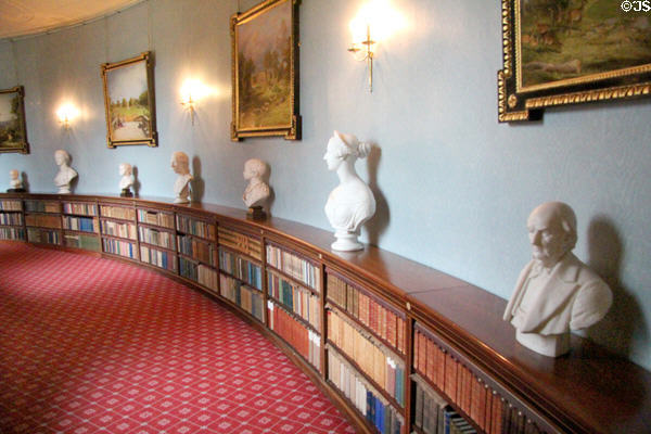 Curved hallway lined with paintings, bust & books at Haddo House. Methlick, Scotland.