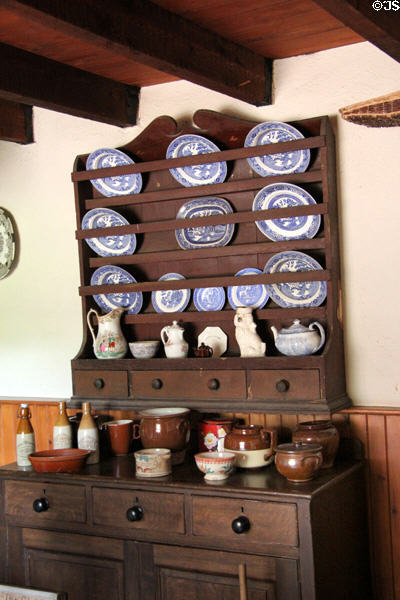 Farmhouse kitchen hutch with plates & ceramic crocks at Pitmedden Garden. Pitmedden, Scotland.