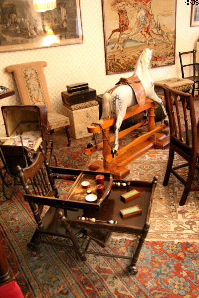 Child's chair with attached tables & rocking horse at Brodie Castle. Brodie, Scotland.