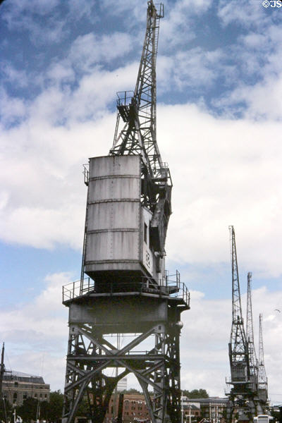 Glimpse of the many cranes once used to unload ships arriving at Floating Harbour. Bristol, England.