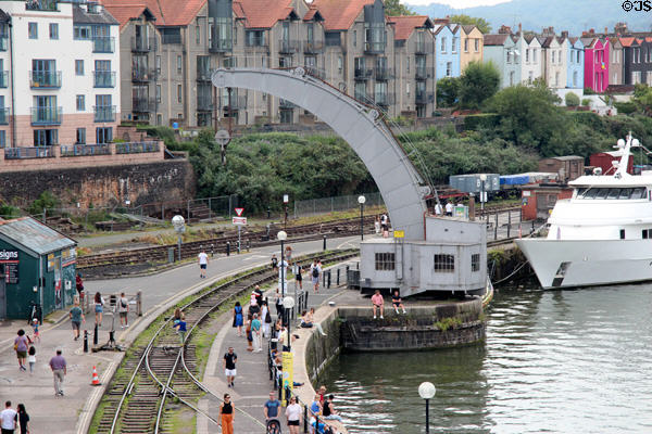 Visitors strolling next to train tracks at Floating Harbour. Bristol, England.