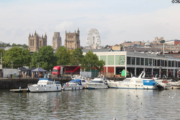 Neo-Gothic towers & Ferris Wheel viewed from Floating Harbour. Bristol, England.