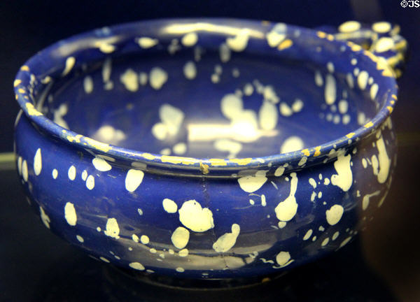 Ceramic porringer (c1680-1700), with decoration meant to resemble candle wax on dark blue glaze, made in London or Brislington at Bristol Museum & Art Gallery. Bristol, England.