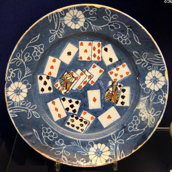 Ceramic plate (1740-65) with playing card decoration in center & border decoration known as sgraffito made in London, Lambeth at Bristol Museum & Art Gallery. Bristol, England.