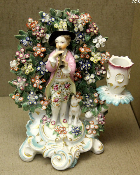 Porcelain candlestick (c1760), one of pair over-glaze-painted & gilded with Rococo scene of shepherd & shepherdess (not shown),made in Chelsea at Bristol Museum & Art Gallery. Bristol, England.