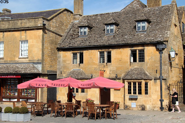 Tavern's outdoor tables on a sunny day in town center. Broadway, England.