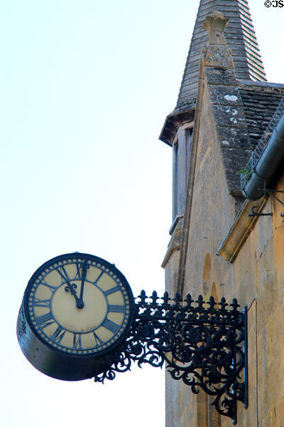 Old fashioned ornate street clock which hangs from historic building near the Broadway Museum & Art Gallery. Broadway, England.