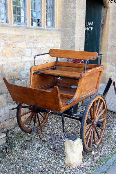 Two wheeled, one horse wagon outside Broadway Museum & Art Gallery. Broadway, England.