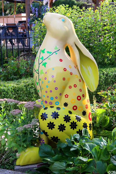 Rabbit sculpture with floral decorations in gardens at Cotswold's Motoring Museum. Bourton-on-the-Water, England.
