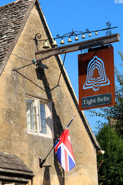 Eight bells pub sign surmounted by eight bells. Chipping Campden, England.