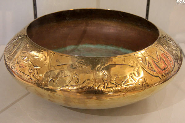 Brass zodiac bowl (1920s) hammered with signs of the zodiac by Gordon Russell at Court Barn Museum. Chipping Campden, England.