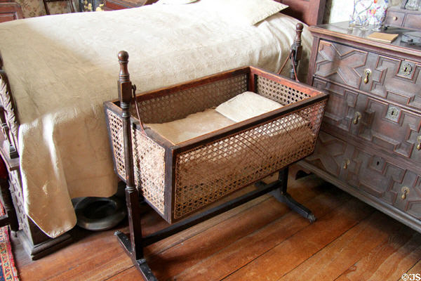 Swinging wicker cradle in Cavalier bedroom at Chastleton House. Moreton-in-Marsh, England.