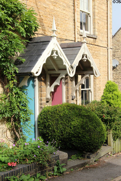 Ornately carved entrance roofs on row houses close to town center. Chipping Norton, England.