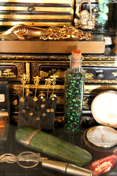 Array of various collectibles, including antique pocket watch at Snowshill Manor. England.