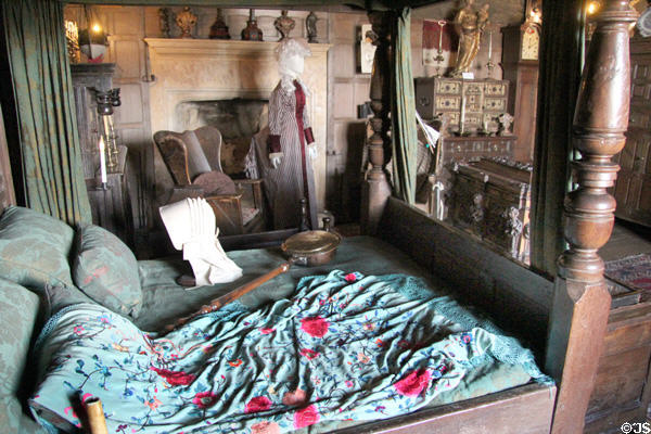 Canopy bed with bed warmer & embroidered pillow cover & coverlet at Snowshill Manor. England.