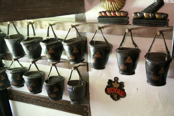 Collection of antique leather fire buckets at Snowshill Manor. England.