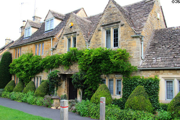 Homes along bank of River Eye. Lower Slaughter, England.