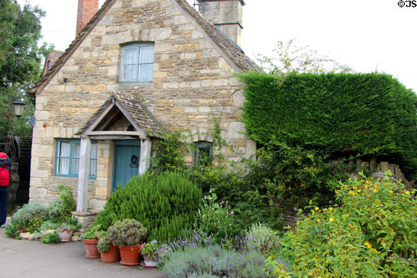 Cotswold stone home with variety of plantings in front. Lower Slaughter, England.