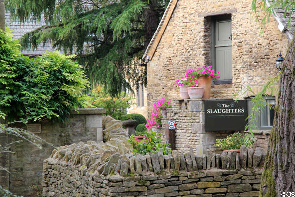 "The Slaughters" constructed of rough stone with dry stone wall. Lower Slaughter, England.