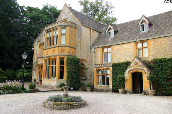 Cotswold stone residence with slate roof pierced by dormer windows. Upper Slaughter, England.