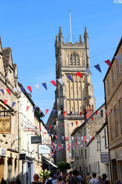 The Church of St John Baptist (12th - 16thC) viewed from narrow medieval street. Cirencester, England.