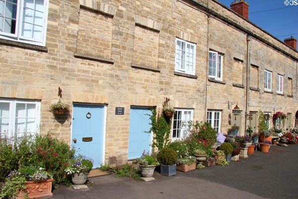 Row homes on Cecily Hill lined by flowering plantings. Cirencester, England.