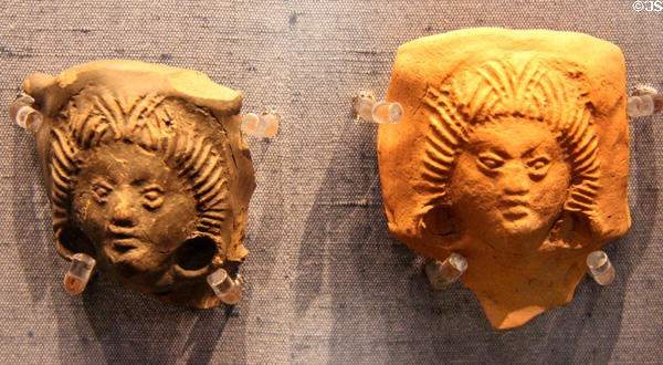 Roman era flagon necks (vessel used for pouring drinks) decorated with women's faces & their elaborate hairstyles at Corinium Museum. Cirencester, England.