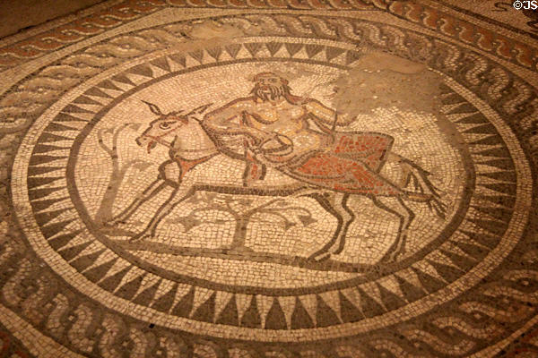 Scene from Seasons Mosaic, depicting Silenus, guardian of Bacchus, riding a donkey, at Corinium Museum. Cirencester, England.