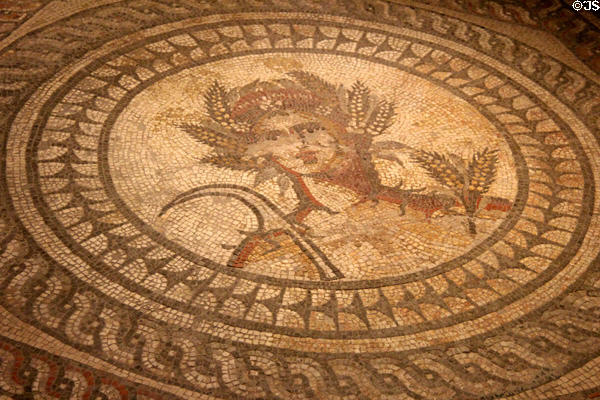 Scene from Seasons Mosaic representing summer & depicting Ceres, goddess of agriculture, carrying a sickle at Corinium Museum. Cirencester, England.