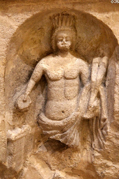 Altar dedicated to Genius Loci who wears a crown, holds a cornucopia in his left hand, and holds a patera or sacrificial bowl in his right hand. Cirencester, England.