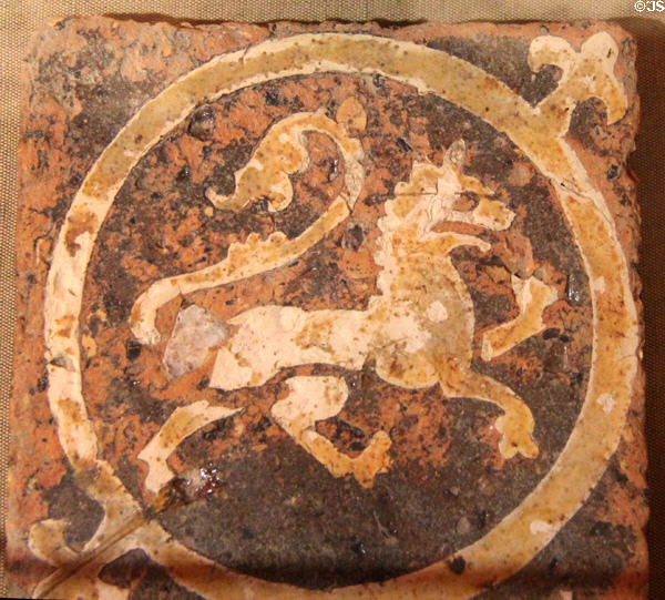 Heraldic floor tile depicting a lion rampant (13thC) from St Mary's Abbey at Corinium Museum. Cirencester, England.