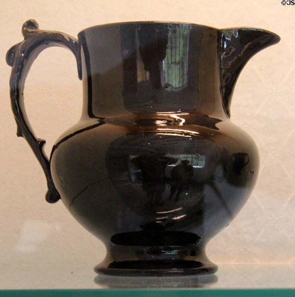 Black glazed earthenware jug with shaped handle (c1720-1790) at Coalport China Museum. Ironbridge, England.