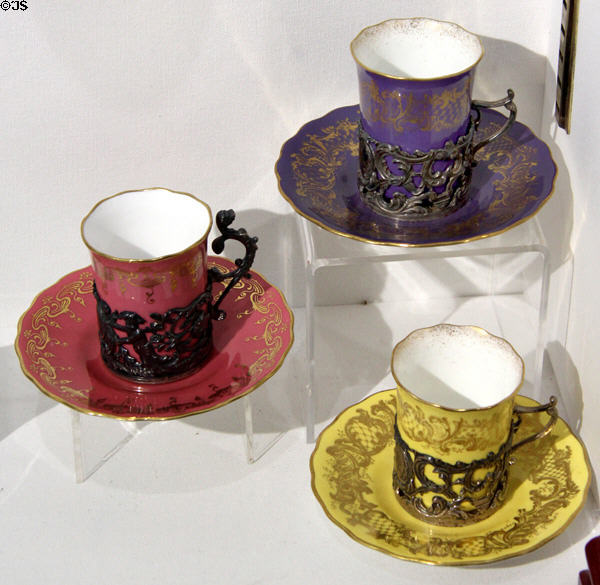 Yellow, pink & violet cups & saucers in silver holders (c1900) by crown Coalport at Coalport China Museum. Ironbridge, England.