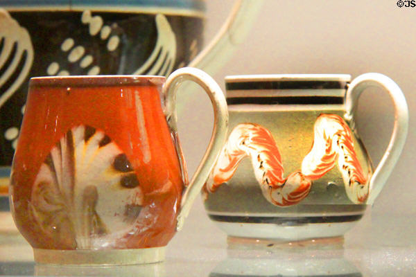 Earthenware mustard pots with slip decoration (early 19thC) prob. from Staffordshire at Potteries Museum & Art Gallery. Hanley, Stoke-on-Trent, England.