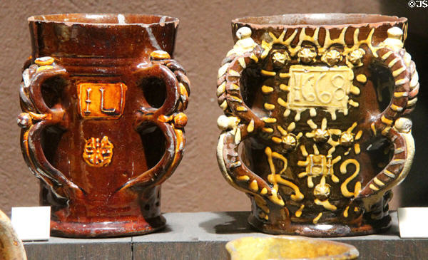 Tyg (1636) by John Livermor of Wrotham, Kent & slip decorated Tyg (1668) by Henry Ifield of Wrotham, Kent at Potteries Museum & Art Gallery. Hanley, Stoke-on-Trent, England.
